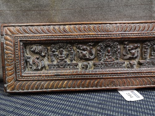 Lot 394 - A Tibetan carved wood manuscript cover, 14th/15th century or later
