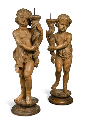 Lot 860 - A pair of carved limewood pricket stands, probably 17th century