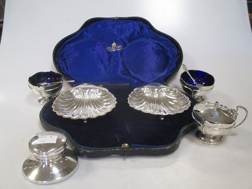 Lot 287 - A carved pair of silver scallop shaped butter...