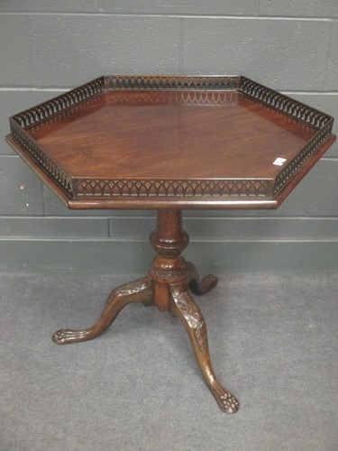 Lot 744 - A Mahogany tripod table with gallery top on...