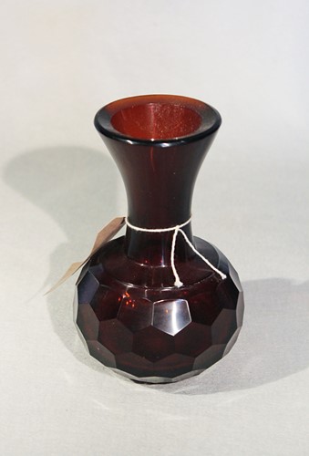 Lot 425 - A Chinese Pekin glass dark amber vase with trumpet neck and faceted body