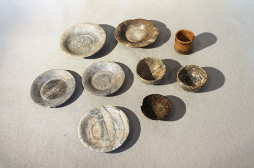 Lot 121 - A Chinese greenstone five-petalled shallow...