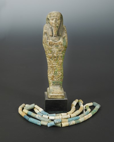 Lot 431 - An Egyptian faience shabti figure, impressed with hieroglyphics