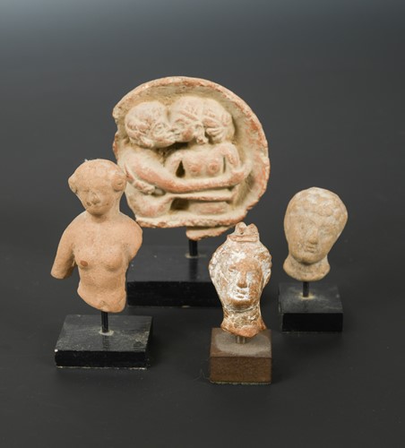 Lot 433 - Four Greek pottery fragmentary heads of male and females