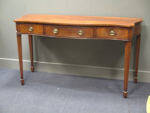 Lot 684 - A mahogany serpentine fronted sideboard in...