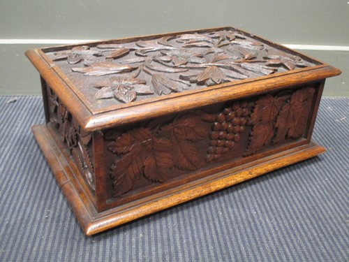 Lot 602 - An oak table casket carved with fruiting vines...