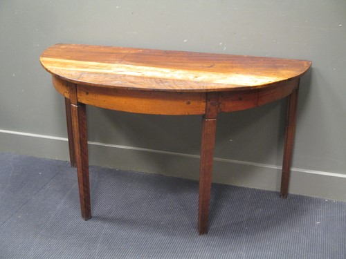 Lot 666 - A continental rustic demi-lune fruitwood table
