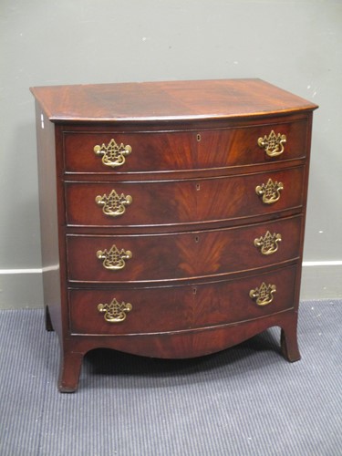 Lot 701 - A George III flame mahogany bow front chest of...