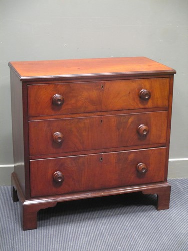 Lot 635 - An early mahogany chest of three long drawers...