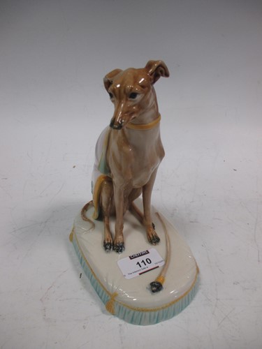 Lot 110 - A majolica model of a seated greyhound,...