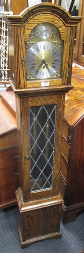 Lot 623 - An modern oak chiming grandmother clock 151cm...