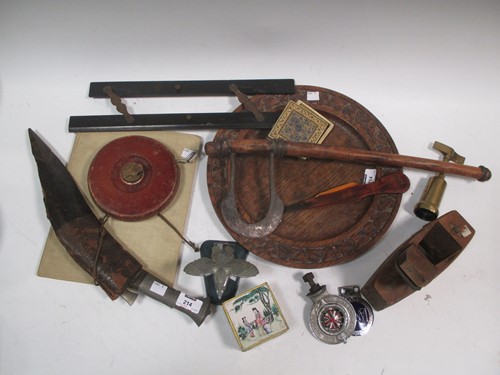 Lot 214 - A kukri knife, car badges, axe, a Singer...