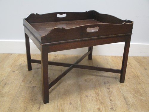 Lot 540 - A mahogany butler's tray on stand / coffee...