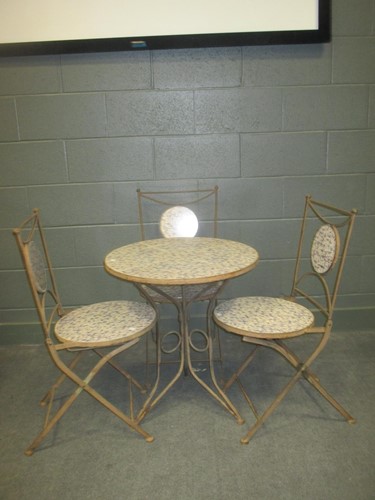 Lot 601 - A wrought iron garden table with blue and...