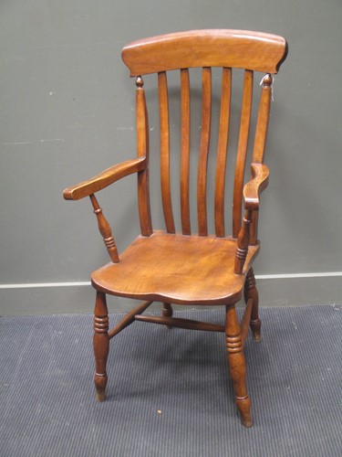 Lot 478 - A 19th century elm high back arm chair