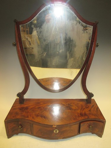 Lot 502 - A George III shield shaped toilet mirror, the...