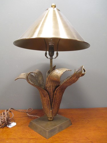 Lot 717 - A contemporary brass effect lamp stylised as...