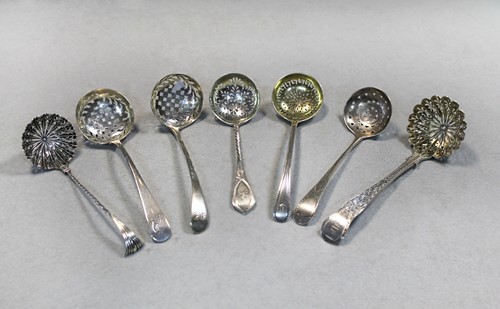 Lot 334 - Three George III 18th century silver sugar sifting spoons together with four Victorian examples