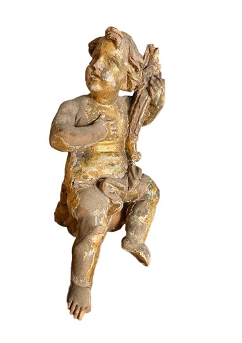 Lot 794 - A carved gilt model putto
