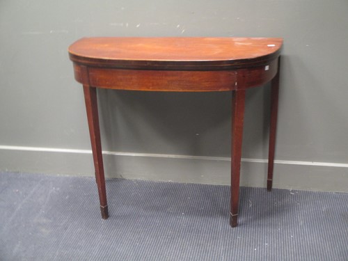 Lot 460 - A George III demi lune foldover top table...