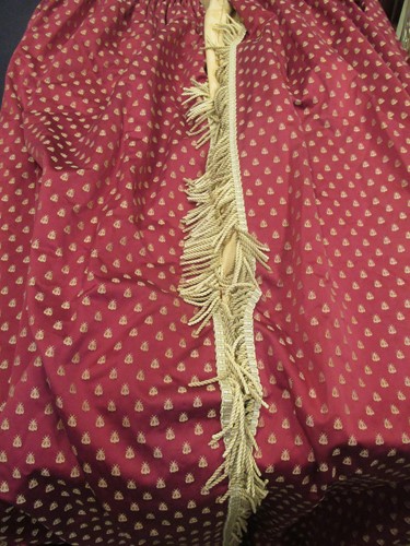 Lot 474 - A pair of red curtains lined with yellow...