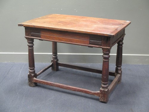 Lot 869 - An oak small dining table, the rectangular top...
