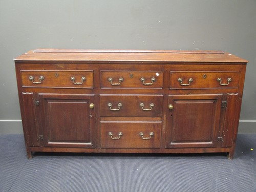 Lot 804 - An oak low dresser, of three drawers over...