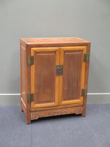 Lot 149 - A Chinese two-coloured wood cupboard, early...
