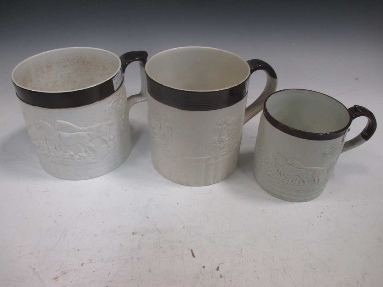 Lot 323 - Three Castleford type pottery porter mugs,...