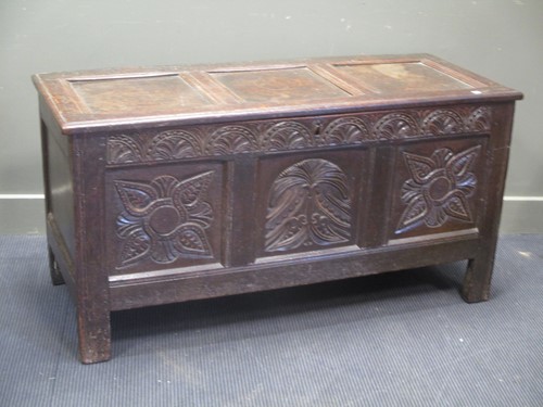 Lot 828 - An oak carved coffer 69 x 136 x 53cm