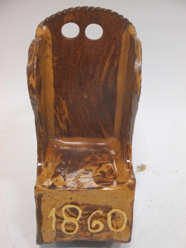 Lot 114 - A treacle glazed pottery model of a lambing...