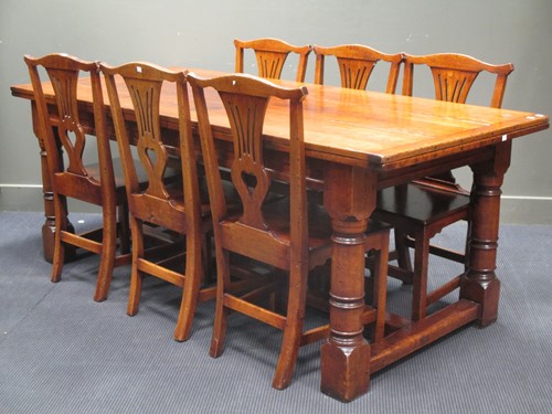 Lot 551 - A reproduction oak dining suite: drawleaf...