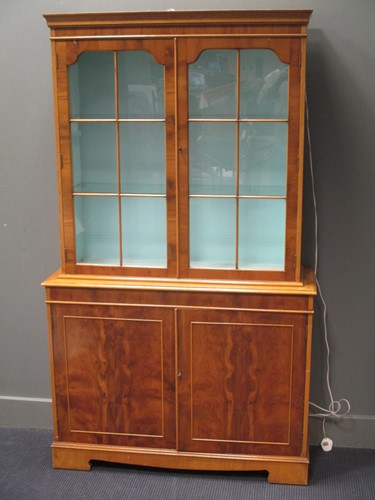 Lot 488 - A yewwood effect glazed top bookcase or...