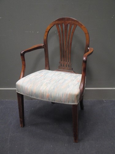 Lot 479 - A mahogany Hepplewhite style arched-back elbow...