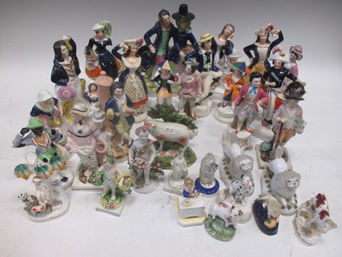 Lot 130 - A collection of English pottery figurines, to...