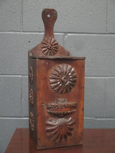 Lot 541 - An oak candle box, applied with carved florets...