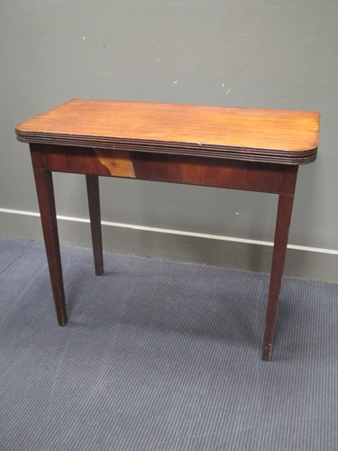 Lot 475 - A 19th century mahogany fold over tea table,...