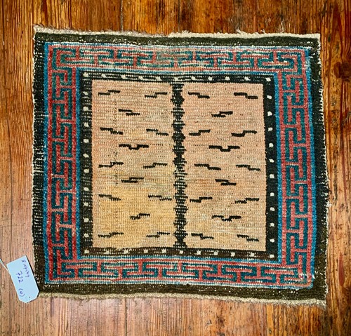 Lot 468 - A Tibetan wool tiger stripe single seat meditation rug, 19th century