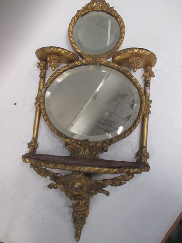 Lot 472 - A set of giltwood mirror backed wall shelves,...