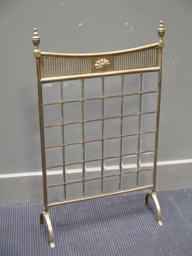 Lot 651 - A brass fire screen with urn finials, 83cm...