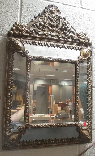Lot 556 - A gilt metal mirror, In Italian Baroque style,...