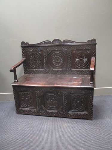 Lot 635 - A 17th century style box seat hall settle with...