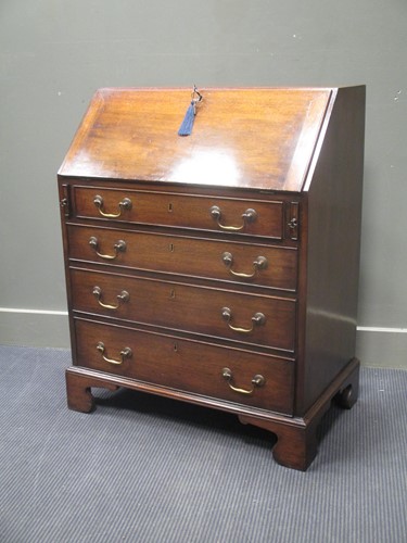 Lot 517 - A George III style mahogany bureau with fitted...