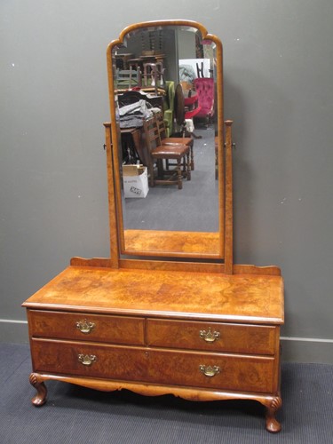 Lot 665 - A figured walnut dressing chest of two short...