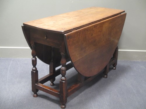 Lot 525 - A 17th century oak oval top gateleg dining...