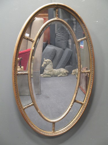Lot 493 - A Sheraton revival gilt framed oval wall...