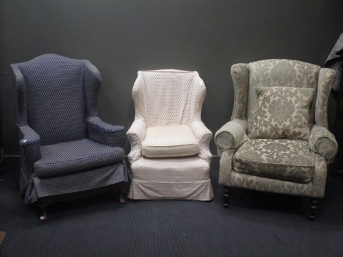 Lot 647 - A modern upholstered wing armchair and an...