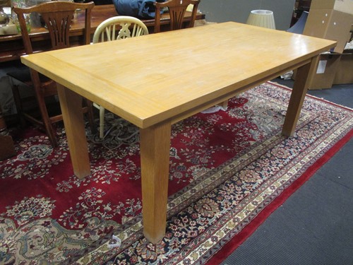 Lot 587 - A modern oak veneer extending dining table by...