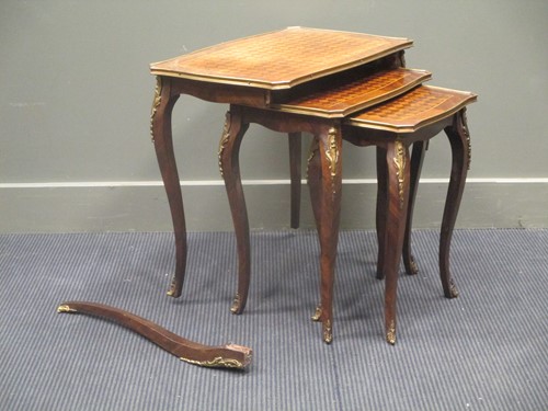 Lot 791 - A French style parquetry top nest of three...