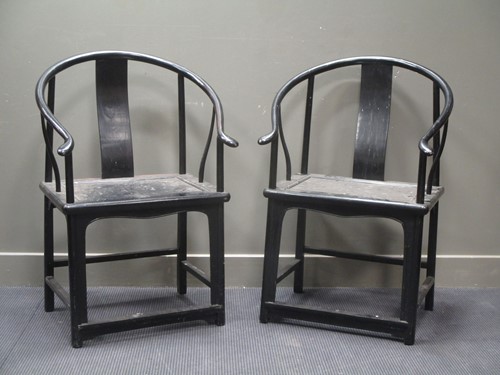 Lot 660 - A pair of Chinese hard wood hoop back arm chairs